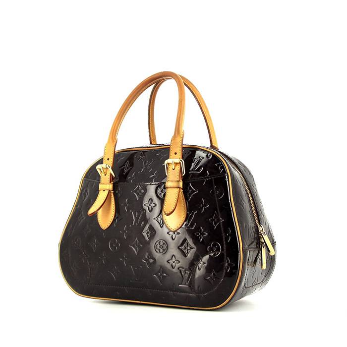 LOUIS VUITTON purple and gold monogram patent leather bag on a