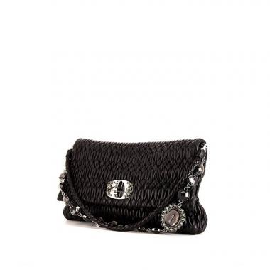 Miu Miu Iconic Crystal bag worn on the shoulder or carried in the hand in black quilted leather
