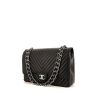 Chanel Timeless Maxi Jumbo handbag in black chevron quilted leather - 00pp thumbnail