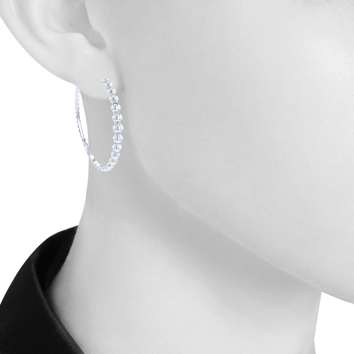With pearls Van Cleef 
Arpels Perlée hoop earrings in white gold