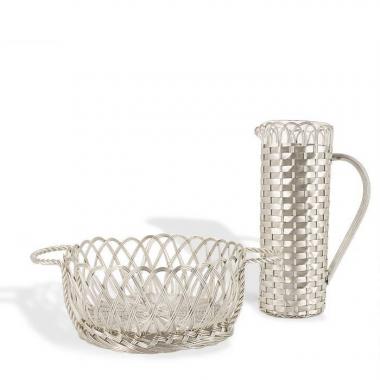 Christian Dior, table set including a pitcher and a basket in silvered metal imitating the work of basketry, signed, from the 1980's