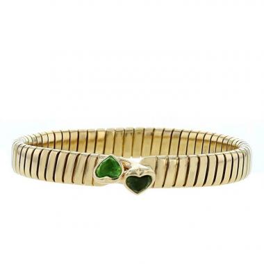 Bracelet époque années 80 ouvrant Bulgari Tubogas en or jaune et tourmalines vertes
