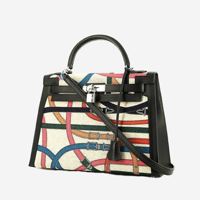 Hermès  Kelly 32 cm Cavalcadour handbag  in beige canvas  and black leather