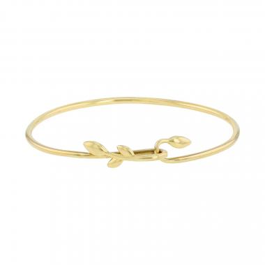 Opening Tiffany & Co Olive Leaf bangle in yellow gold