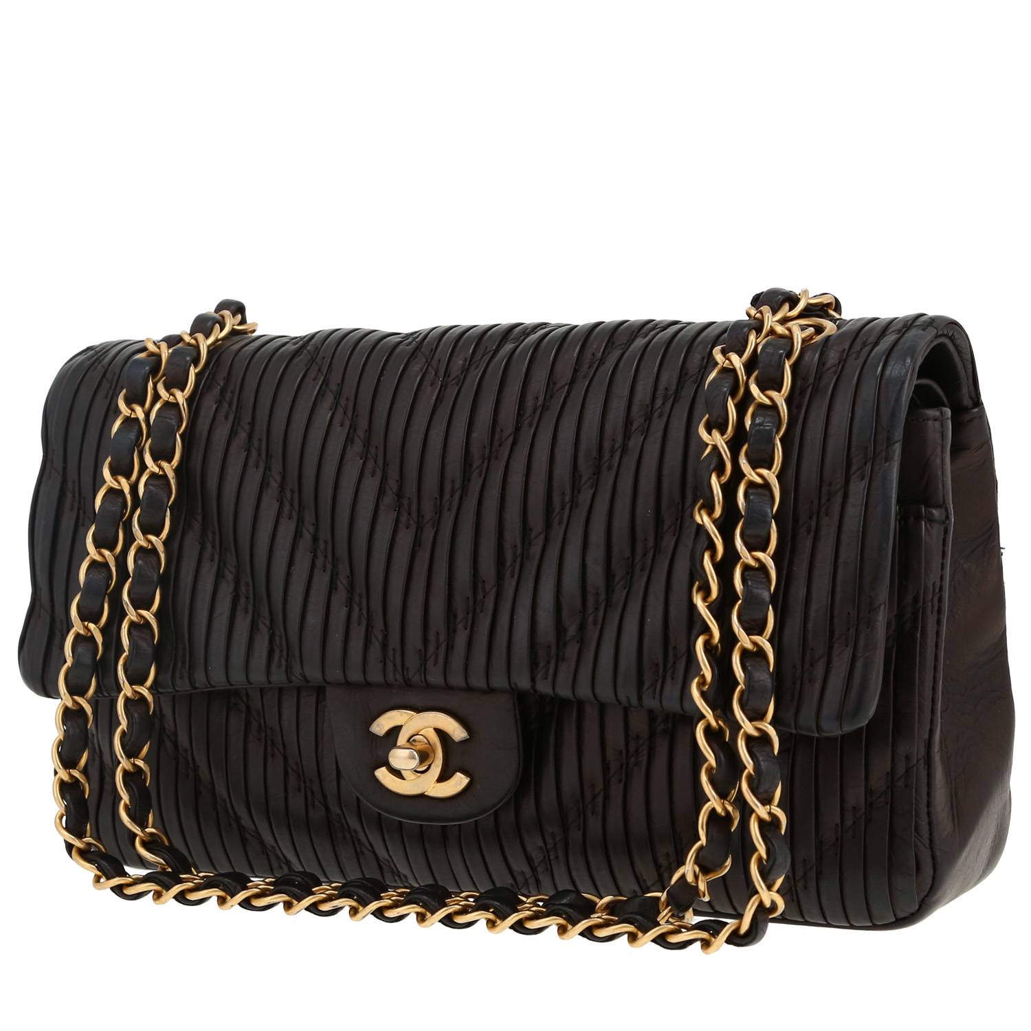 Chanel Timeless Classic medium model handbag in black chevron quilted leather