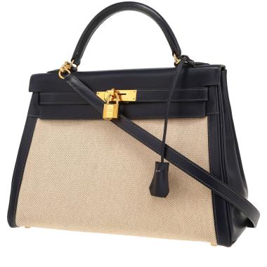 Hermès  Kelly 32 cm handbag  in navy blue box leather  and beige canvas