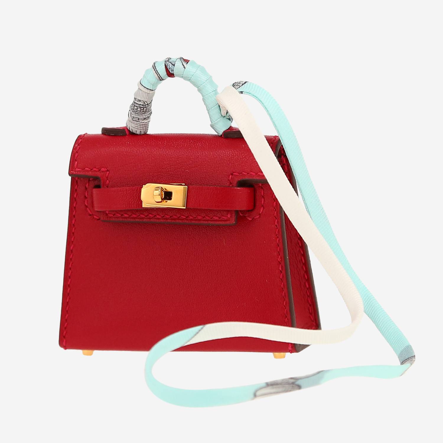 Hermès  Kelly Twilly bag charm bag accessory  in red Tadelakt leather  and multicolor silk