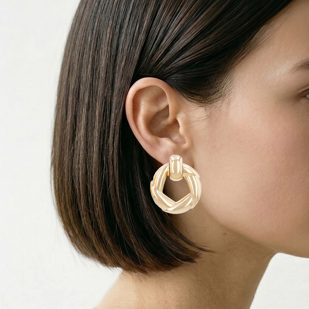 A pair of hinged Cartier 1990s-style clip-on earrings in yellow gold
